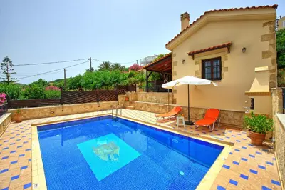 a swimming pool in front of a house at Villa Romantic Sevi by PosarelliVillas in Káto Vení