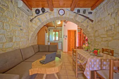 a living room with a couch and a laptop on a table at Villa Nipos by PosarelliVillas in Vryses