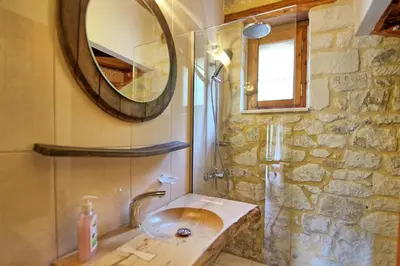 a bathroom with a sink and a mirror at Villa Nipos by PosarelliVillas in Vryses