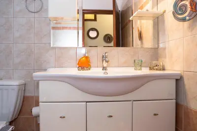 a bathroom with a sink and a toilet at Aroma of the Sea in Kissamos