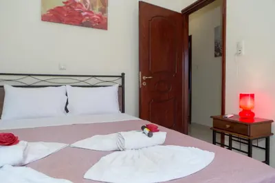 a bedroom with a bed with two towels and a candle at Aroma of the Sea in Kissamos