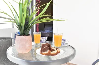 a table with a plate of bread and two glasses of orange juice at Aroma of the Sea in Kissamos