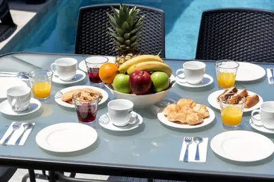 a table with a bowl of fruit on top of it at Villa Ampela by PosarelliVillas in Agia Marina Nea Kydonias