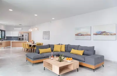 a living room with a couch and a table at Villa Zaneti by PosarelliVillas in Agia Marina Nea Kydonias