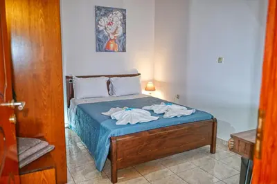 a bedroom with a bed with two towels on it at Armonia in Kissamos