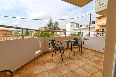 a balcony with a table and chairs on it at Armonia in Kissamos