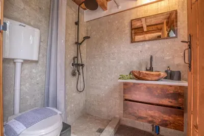 a bathroom with a sink and a toilet and a shower at Wooden House Apts - Between Balos & Elafonissi in Kaláthenai
