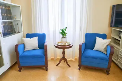 two blue chairs and a table in a room at Philoxenia Residence Chania City Centre in Chania Town
