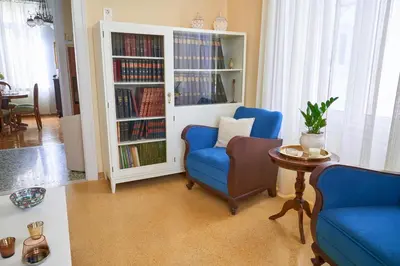 a living room with a book shelf filled with books at Philoxenia Residence Chania City Centre in Chania Town