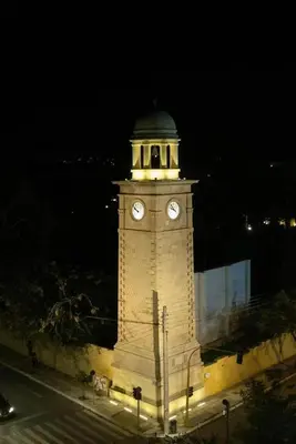 a clock tower at night with a light on it at Philoxenia Residence Chania City Centre in Chania Town