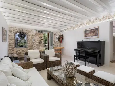 a living room with a couch and a piano at Ondathaki Pirgos in Pírgos Psilonérou