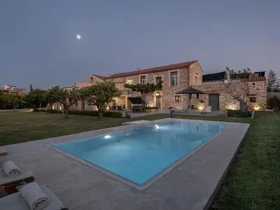 a large swimming pool in front of a house at Ondathaki Pirgos in Pírgos Psilonérou