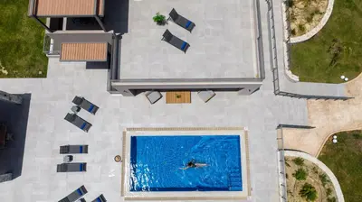 an overhead view of a person swimming in a pool at Imperium Luxury Villas-Sauna, Jacuzzi, Heated Pool & Gym-Chania in Kato Galatas