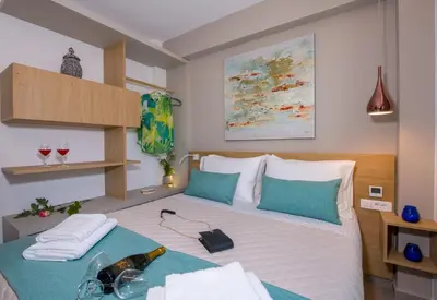 a bedroom with a bed with a bottle of wine on it at Imperium Luxury Villas-Sauna, Jacuzzi, Heated Pool & Gym-Chania in Kato Galatas