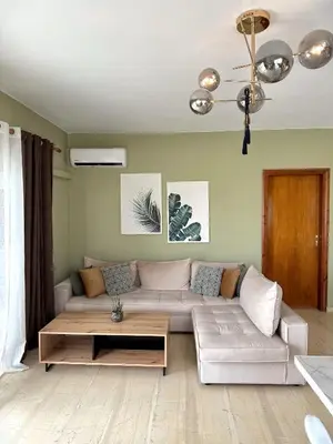 a living room with a couch and a coffee table at Nidus 101 in Souda
