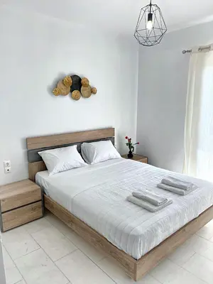 a bedroom with a bed with a teddy bear on the wall at Nidus 101 in Souda