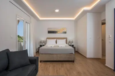a bedroom with a bed and a couch at Urban Residences Chania in Chania Town