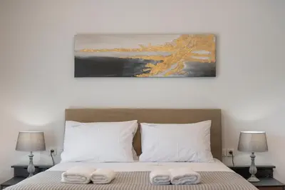 a bedroom with a bed with two towels on it at Urban Residences Chania in Chania Town