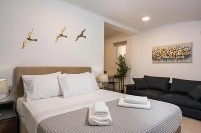 a bedroom with a bed and a couch at Urban Residences Chania in Chania Town