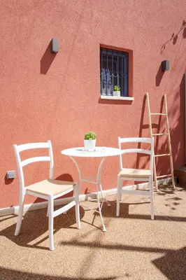 two chairs and a table and a table and chairs at Mouse House with Sea View and Mini Pool in Plataniás
