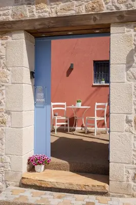 a doorway to a patio with a table and chairs at Mouse House with Sea View and Mini Pool in Plataniás