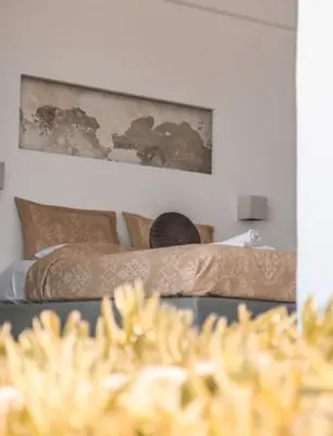 a bedroom with two beds and a painting on the wall at Esperanto seafront studio in Agia Marina Nea Kydonias