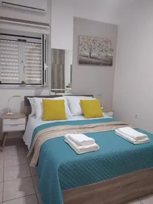 a bedroom with a large bed with towels on it at Cozy Home (close to the beach) in Agia Marina Nea Kydonias