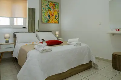 a bedroom with a bed with towels on it at Cozy Home (close to the beach) in Agia Marina Nea Kydonias