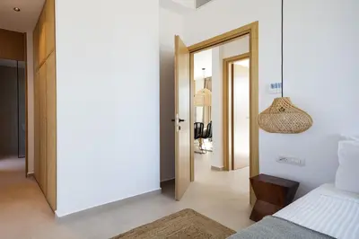 a bedroom with a bed and a pendant light at Villa al Sur in Chania Town
