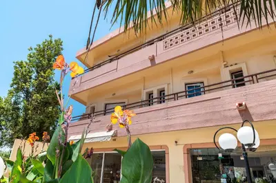 a building with a balcony on top of it at Louladakis Apartments in Kolymvari