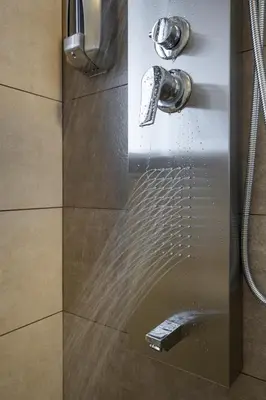 a shower with a glass door with a shower head at INDIGO BLUE Seaside Deluxe Apartments in Kissamos