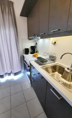 a kitchen with a sink and a counter top at Stelios Studios Sougia in Sougia