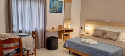 a hotel room with a bed and a table with a table at Stelios Studios Sougia in Sougia