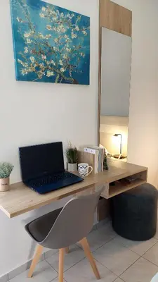 a desk with a laptop computer on top of it at Stelios Studios Sougia in Sougia