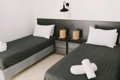 a bedroom with two beds with white crosses on them at Grey House in Chorafakia