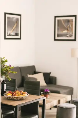 a living room with a table with fruit on it at Grey House in Chorafakia