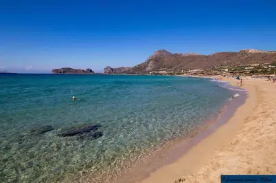 a beach with a group of people in the water at Stefanis traditional house - Kampos in Kámbos