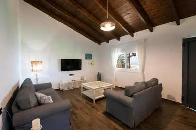 a living room with two couches and a tv at jAne's house in Ravdhoúkha