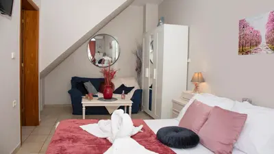 a bedroom with a white bed with a red blanket at Castel View Experience in Kissamos