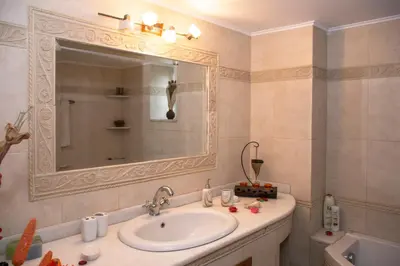 a bathroom with a sink and a mirror at Castel View Experience in Kissamos