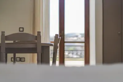 a table and a chair in front of a window at Kera Studios in Kalyves