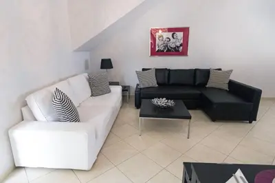 a living room with a couch and a table at Aria apts 100 m from the beach by PosarelliVillas in Kolymvari