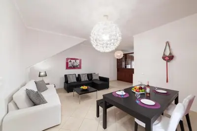 a living room with a table and a couch at Aria apts 100 m from the beach by PosarelliVillas in Kolymvari