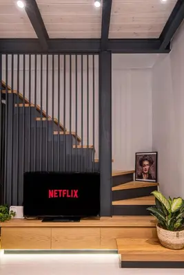 a television sitting on a table in front of stairs at Chania Residence - City centre maisonette in Chania Town
