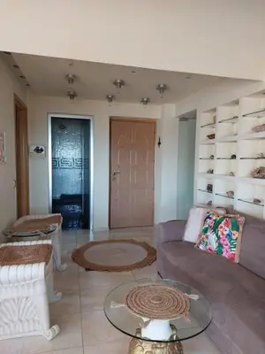 a living room with a couch and a table at Aphrodite View in Korakiaí