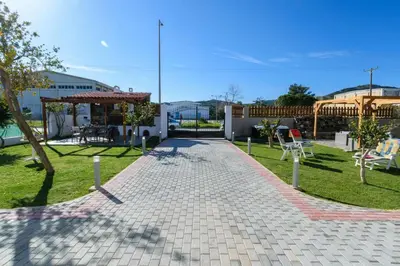 a brick walkway in a yard with a gazebo at Villa Albion in Kolymvari