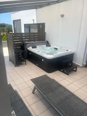 a hot tub sitting on top of a patio at Ledakis House with Jacuzzi in Frangokastello