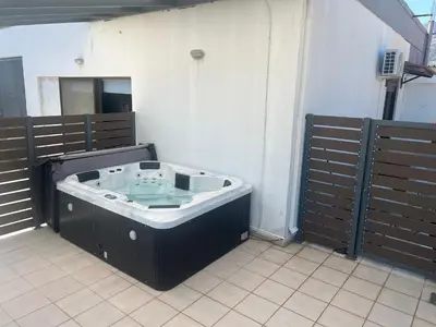 a jacuzzi tub in a room with wooden fences at Ledakis House with Jacuzzi in Frangokastello