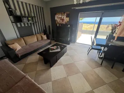 a living room with a couch and a table at Ledakis House with Jacuzzi in Frangokastello