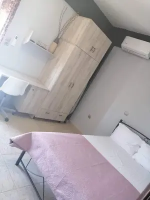 a small room with a bed and a cabinet at Ledakis House with Jacuzzi in Frangokastello